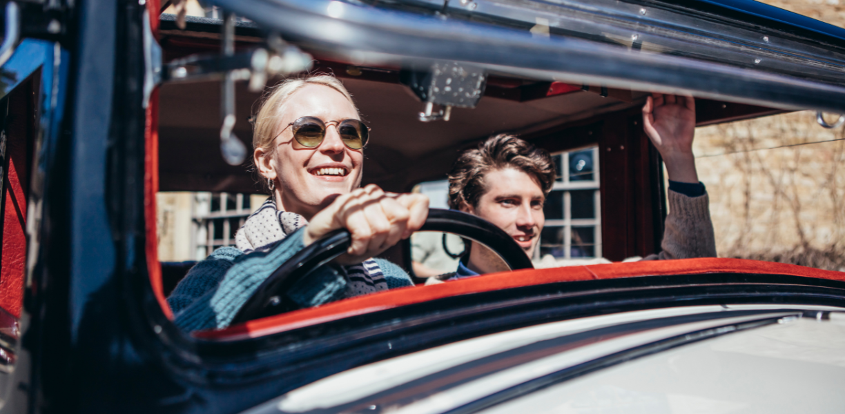 Couple driving in a classic car